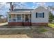 Charming bungalow-style home with a welcoming front porch, brick foundation, and neutral siding at 201 Wiley Ave, York, SC 29745