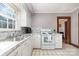 Galley kitchen with white cabinets, marble countertops, and stainless-steel sink at 201 Wiley Ave, York, SC 29745