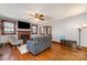 Cozy living room with hardwood floors, brick fireplace, ceiling fan, and ample natural light at 201 Wiley Ave, York, SC 29745