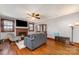 Cozy living room with hardwood floors, brick fireplace, ceiling fan, and ample natural light at 201 Wiley Ave, York, SC 29745