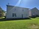 View of backyard and back of house, with a bright lawn at 2108 Cranberry Woods Ct, Charlotte, NC 28208