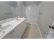 Bright bathroom features double sink vanity and shower-tub combo at 2108 Cranberry Woods Ct, Charlotte, NC 28208