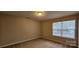 Bedroom with neutral paint, plush carpet, a window, and a ceiling light at 2108 Cranberry Woods Ct, Charlotte, NC 28208
