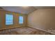 A bright bedroom featuring neutral paint, plush carpet and natural light from its two sunny windows at 2108 Cranberry Woods Ct, Charlotte, NC 28208