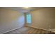 A bright bedroom with neutral paint and plush carpet, lit by a recessed light fixture and a window at 2108 Cranberry Woods Ct, Charlotte, NC 28208