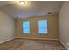Bright and airy bedroom with neutral carpeting, large windows, and ample natural light at 2108 Cranberry Woods Ct, Charlotte, NC 28208