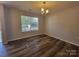 Bedroom featuring neutral paint and laminate flooring, offering a versatile space at 2108 Cranberry Woods Ct, Charlotte, NC 28208