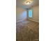 Neutral bedroom with tan carpet, walls, ceiling fixture, and window with mini blinds at 2108 Cranberry Woods Ct, Charlotte, NC 28208