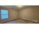 A bright bedroom with neutral paint and plush carpet, lit by a recessed light fixture and a window at 2108 Cranberry Woods Ct, Charlotte, NC 28208