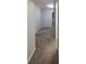 Hallway with tan carpeting, neutral walls and base trim leading to various rooms at 2108 Cranberry Woods Ct, Charlotte, NC 28208
