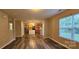 Spacious living room featuring wood-look floors and large windows offering plenty of natural light at 2108 Cranberry Woods Ct, Charlotte, NC 28208