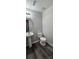 Powder room with a pedestal sink, toilet, and wood-look flooring at 2108 Cranberry Woods Ct, Charlotte, NC 28208