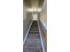 Carpeted staircase with a wooden handrail, providing access to the upper level of the home at 2108 Cranberry Woods Ct, Charlotte, NC 28208