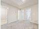 Bright bedroom with neutral carpet and paint, featuring multiple entryways and ample natural light at 2130 Old Rivers Rd, Concord, NC 28027