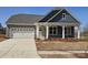 Charming single-story home featuring a stone facade, attached two-car garage and covered front entrance at 218 Miramar Dr, York, SC 29745