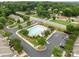 Aerial view of a community pool with a large sun deck and ample parking spaces at 2592 Brackley Nw Pl, Concord, NC 28027