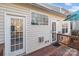 Exterior view of the house leading to a wood deck with a table and umbrella at 2592 Brackley Nw Pl, Concord, NC 28027