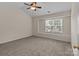 Bright bedroom with a ceiling fan and a window offering natural light and outdoor views at 2592 Brackley Nw Pl, Concord, NC 28027