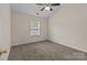 Bedroom featuring carpet flooring, a window overlooking the backyard, and a ceiling fan at 2592 Brackley Nw Pl, Concord, NC 28027