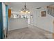 Bright dining area with neutral carpet and an elegant chandelier at 2592 Brackley Nw Pl, Concord, NC 28027