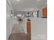 Inviting entryway leading to a carpeted staircase, living area, and kitchen with tile flooring at 2592 Brackley Nw Pl, Concord, NC 28027