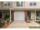 Exterior view of townhome featuring a one-car garage and lovely front porch area at 2592 Brackley Nw Pl, Concord, NC 28027
