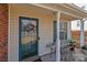 Cozy front porch featuring a wreath, bench, and lush potted plants, creating a welcoming entrance at 2592 Brackley Nw Pl, Concord, NC 28027