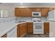Kitchen with white appliances and modern backsplash at 2592 Brackley Nw Pl, Concord, NC 28027