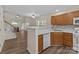 Kitchen featuring wood cabinetry and an open view of the living area at 2592 Brackley Nw Pl, Concord, NC 28027