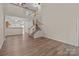 Large living room with tall ceilings, an open floor plan, and wood-look flooring at 2592 Brackley Nw Pl, Concord, NC 28027