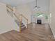 Spacious living room with stairs and fireplace with modern flooring at 2592 Brackley Nw Pl, Concord, NC 28027