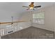 Loft area with carpet flooring, railing, and window overlooking the backyard at 2592 Brackley Nw Pl, Concord, NC 28027