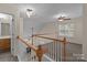 Hallway loft area featuring wood and white railings and ceiling fans at 2592 Brackley Nw Pl, Concord, NC 28027