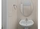 Charming powder room with a pedestal sink and a decorative mirror at 2592 Brackley Nw Pl, Concord, NC 28027