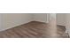 An empty room featuring modern wood flooring with white trim and neutral colored walls at 2592 Brackley Nw Pl, Concord, NC 28027