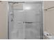 Shower with glass doors and white tiled walls at 2592 Brackley Nw Pl, Concord, NC 28027