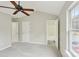 Bedroom with neutral walls, plush carpet, ceiling fan and two doors: closet and en suite bathroom at 3010 Uxbridge Woods Ct, Charlotte, NC 28205