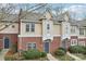 Charming townhome with brick and shingle exterior, featuring a well-manicured front yard and inviting entrance at 3010 Uxbridge Woods Ct, Charlotte, NC 28205