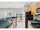 Kitchen features an eat-in breakfast bar, stainless steel appliances, and tile floors at 3010 Uxbridge Woods Ct, Charlotte, NC 28205