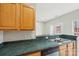 Kitchen with stainless steel sink, dishwasher and view of breakfast nook with glass doors leading to the outside at 3010 Uxbridge Woods Ct, Charlotte, NC 28205