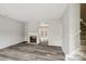 Bright living room featuring a fireplace, wood-look floors, neutral paint, and entry to a patio at 3010 Uxbridge Woods Ct, Charlotte, NC 28205