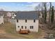 Back of house with deck, multiple windows, and a well-maintained lawn at 302 Flanders Dr, Mooresville, NC 28117