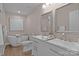 Well-lit bathroom with double vanity, soaking tub and modern fixtures at 302 Flanders Dr, Mooresville, NC 28117