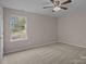 This bedroom features neutral walls, carpeted floors and a ceiling fan at 302 Flanders Dr, Mooresville, NC 28117