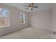 This carpeted bedroom has two windows which allow for plenty of natural light at 302 Flanders Dr, Mooresville, NC 28117