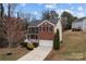 Charming two-story brick home with a well-manicured lawn and attached two-car garage at 302 Flanders Dr, Mooresville, NC 28117