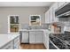 Bright kitchen featuring stainless steel appliances, white cabinets, quartz countertops, and a convenient island at 302 Flanders Dr, Mooresville, NC 28117