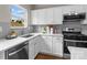 Well-lit kitchen featuring stainless steel appliances, white cabinets, and countertops with a view from the window at 302 Flanders Dr, Mooresville, NC 28117