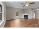 Bright living room with a fireplace, hardwood flooring, and a large window at 302 Flanders Dr, Mooresville, NC 28117