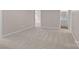 Spacious and empty living room features neutral carpet and fresh paint at 302 Flanders Dr, Mooresville, NC 28117